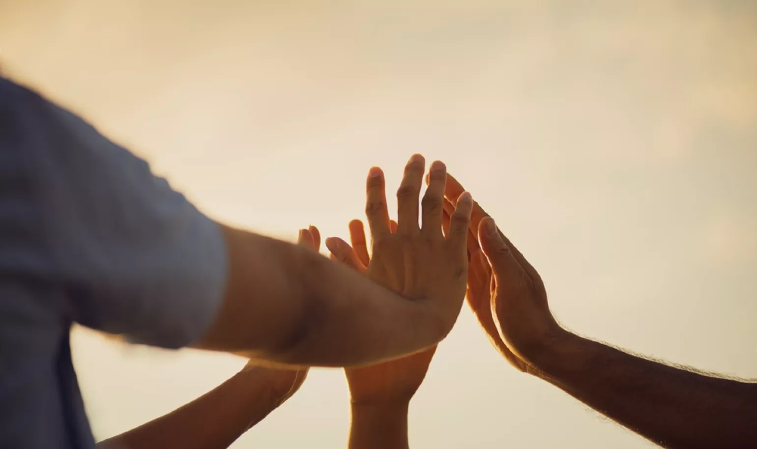 Hands coming together in a group