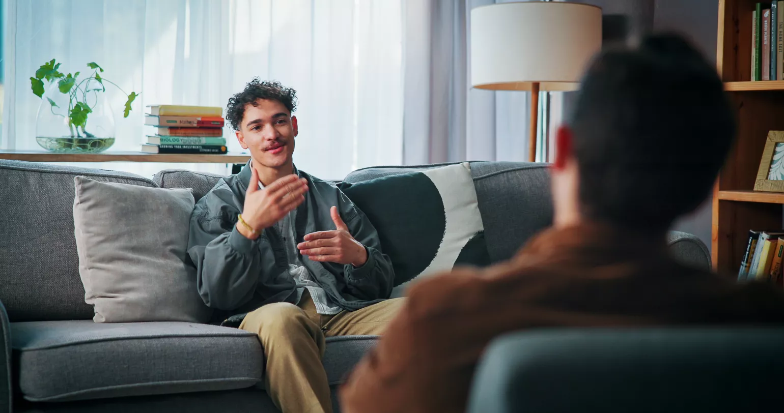 Man sitting on couch with therapist