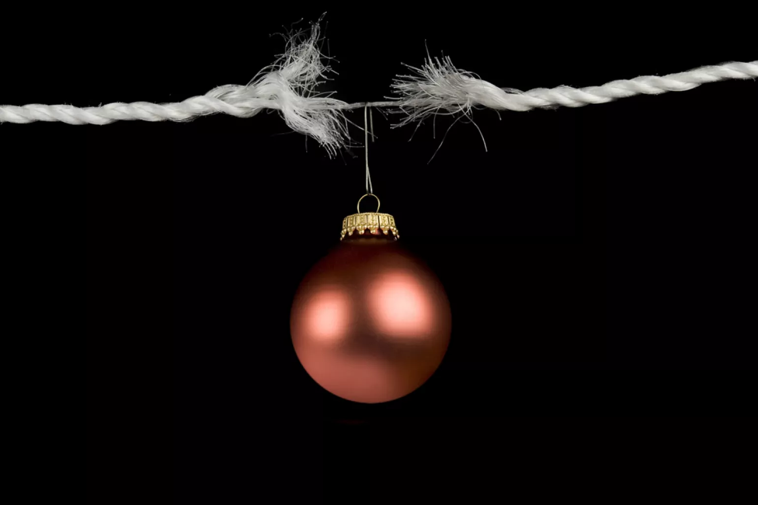 Red Ornament hanging from torn rope