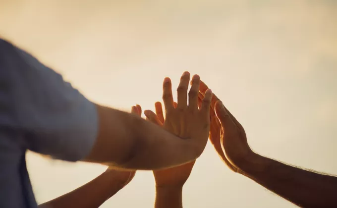 Hands coming together in a group
