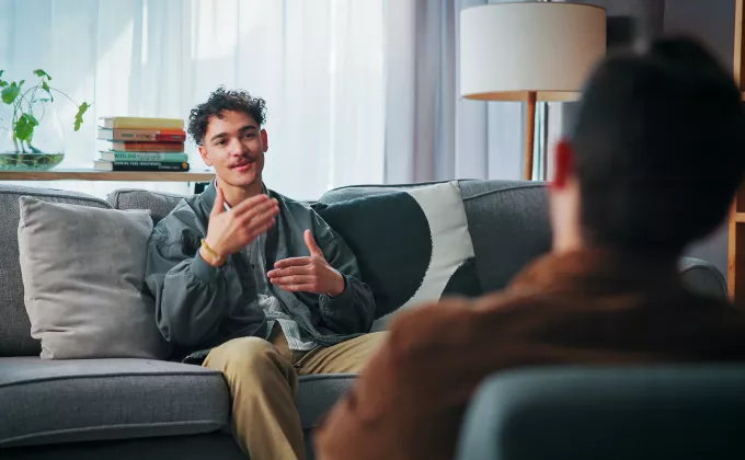Man sitting on couch with therapist